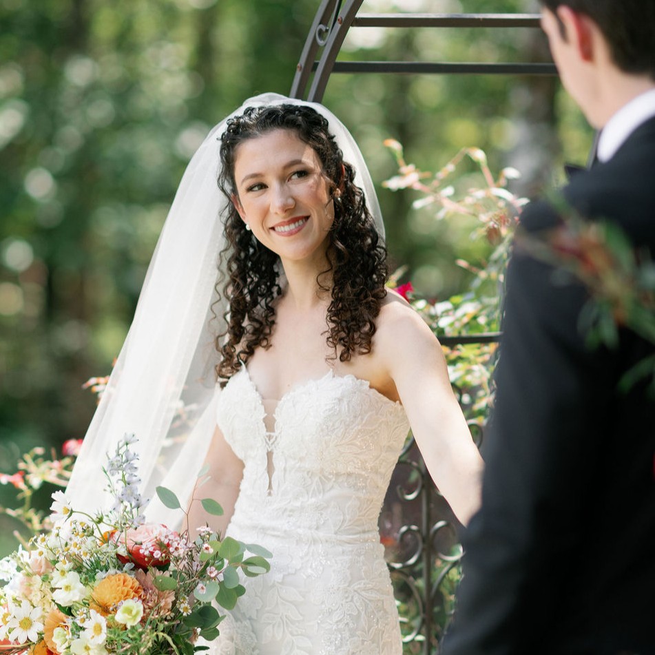 Claire on her wedding day, holding her bouquet